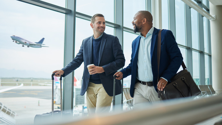 Two businessmen walking in an airport