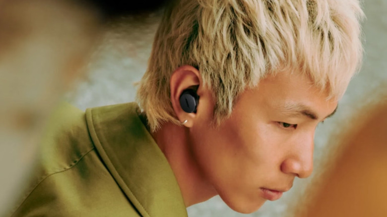A person wearing the Bose QuietComfort Earbuds
