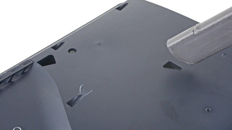 PlayStation 5 vacuum holes in the interior shell with vacuum head in view.