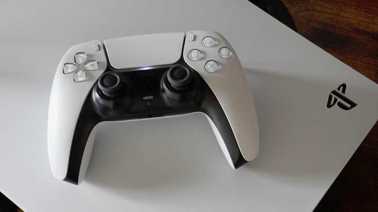 PlayStation 5 DualSense controller resting atop the console.
