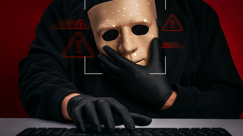 a hacker holding a fake mask