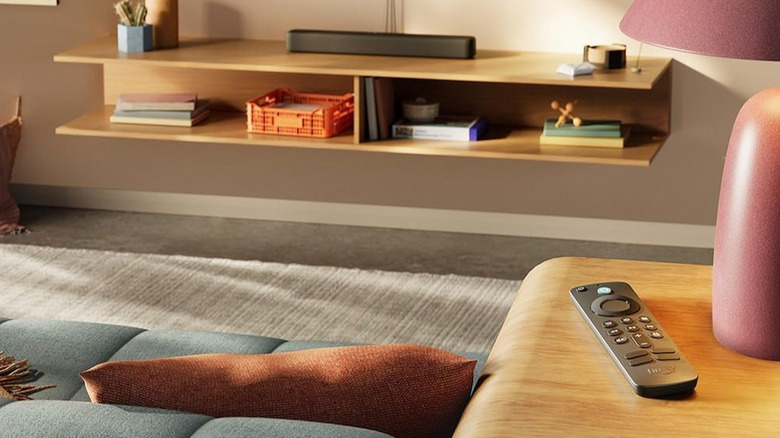 An Amazon Fire TV Stick Remote on a wooden table in a living room