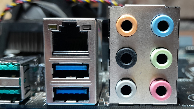 A closeup of a computer motherboard showing USB Type-A ports with blue plastic inserts