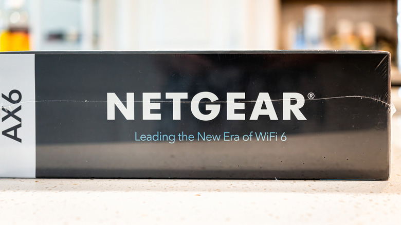 Netgear AX6 Wi-Fi 6 router in box on a table sealed up.