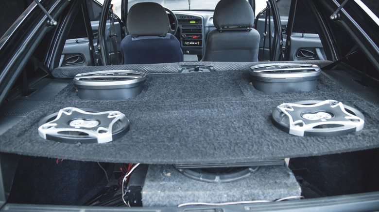Speakers and a subwoofer in a car's boot, or rear cargo area.
