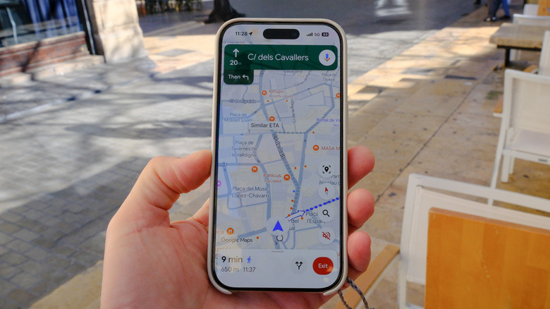 A Google Maps user holding a phone