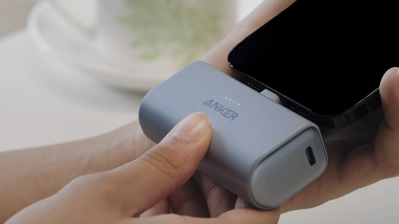 An Anker Nano Power Bank showing lights when connected to a phone
