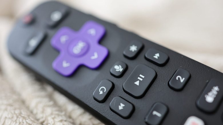 A Roku remote placed on its side.