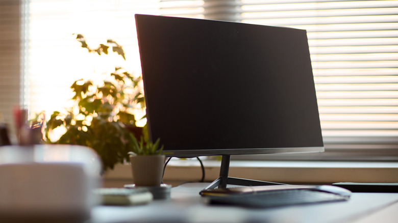 A computer monitor on a desk.