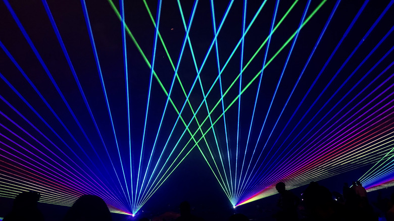 Bright laser light show inside a venue or a club.