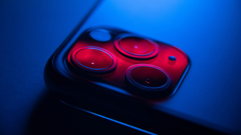 A red neon glow visible on a phone's rear camera module.