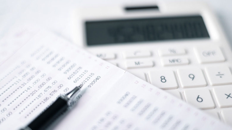 Close-up of a bank statament next to a calculator