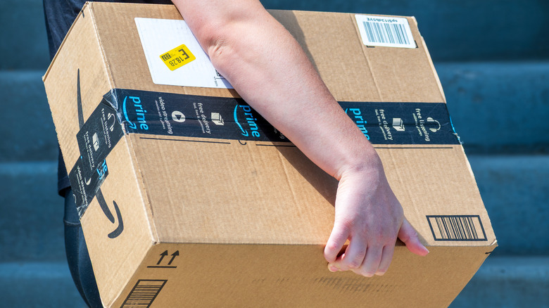 An Amazon driver delivers an Amazon Prime package