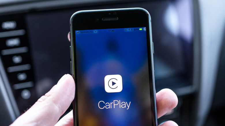 A photo of an iPhone connected to Apple CarPlay.