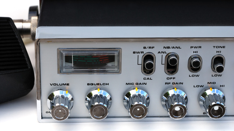 A radio tuner with various control knobs on the front.
