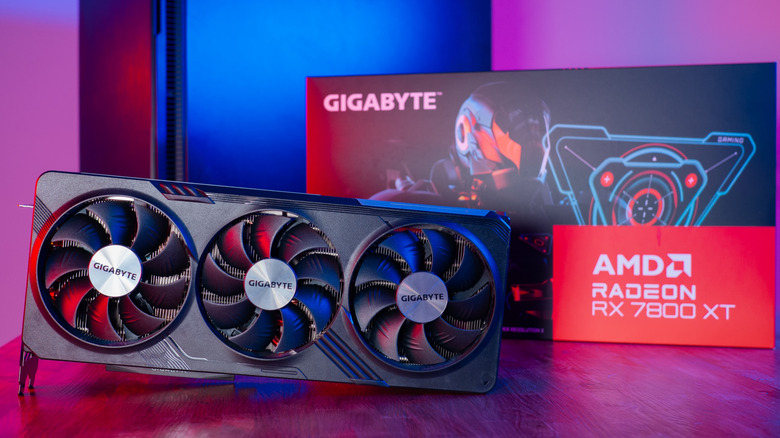 An AMD Radeon RX 780 XT sitting on a wooden table in front of its box