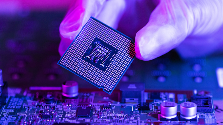 CPU being held above motherboard