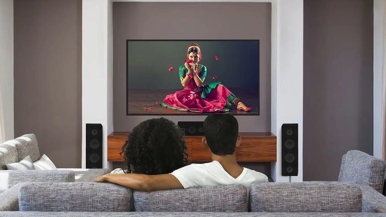 A couple watching Dolby Vision content on a TV