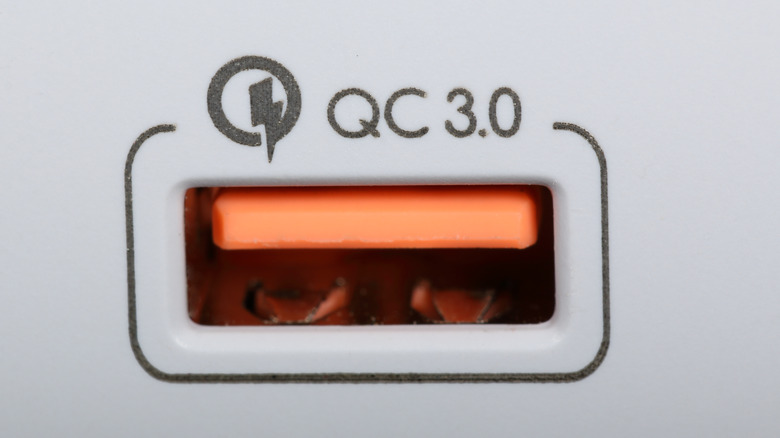 An orange Qualcomm Quick Charge 3.0 port, which is sometimes used instead of a green tab.
