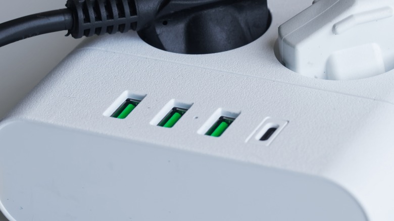 Three green USB ports on a power conditioner.