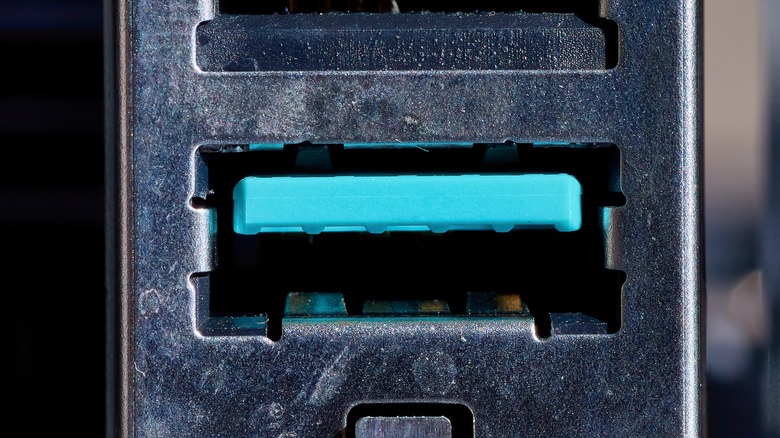 A close-up photograph of a teal USB port.