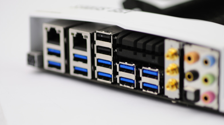 The back of a motherboard with several USB ports.