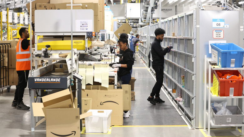 Amazon employees sorting products at a warehouse fulfillment center