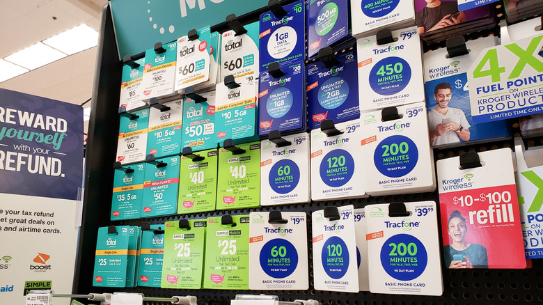 Prepaid phone cards in a store in 2020, including TracFone brands.