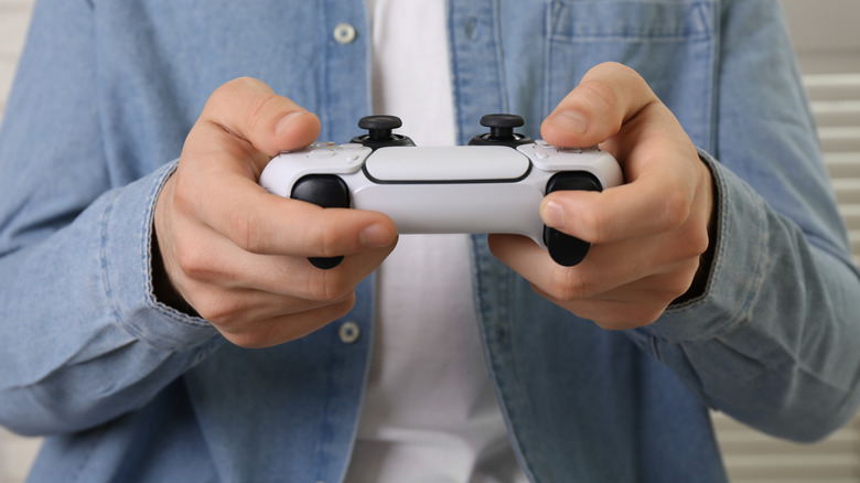 Person holding DualSense controller
