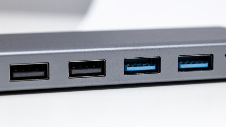 Close up of USB ports in a hub with different colors, blue and black.