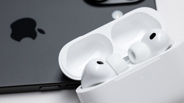 The AirPods Pro placed next to an iPhone.