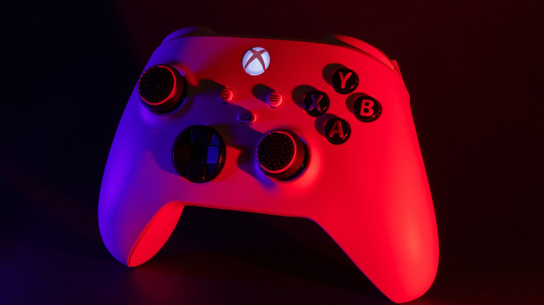 An Xbox Series X controller with its logo button illuminated.