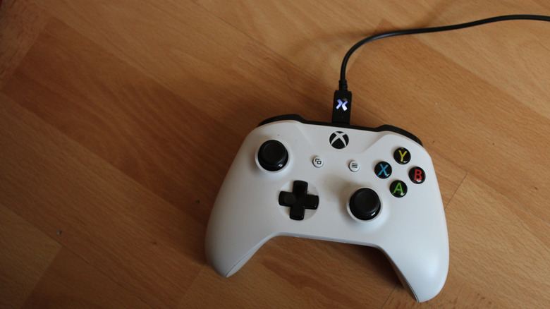An Xbox One controller connected with a USB cable.