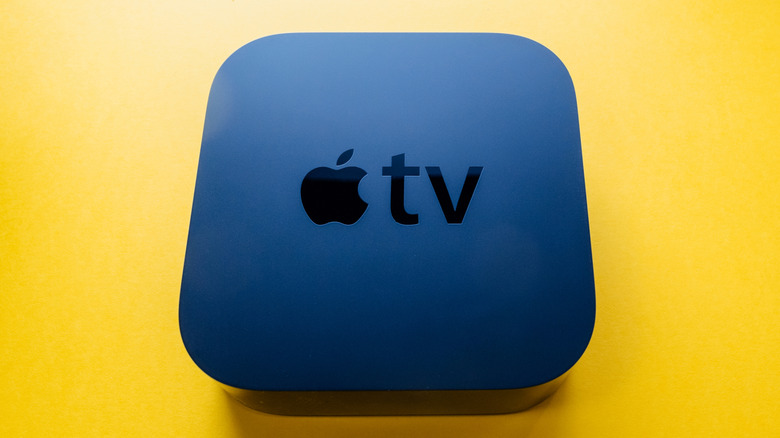Top view of Apple TV 4K streaming device on a yellow background