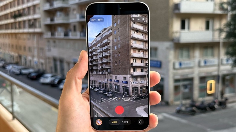 A hand holding an iPhone 17 Pro Max ready to record a video
