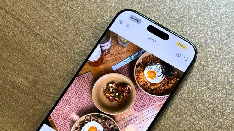 An iPhone on a table with the Photos app opened up