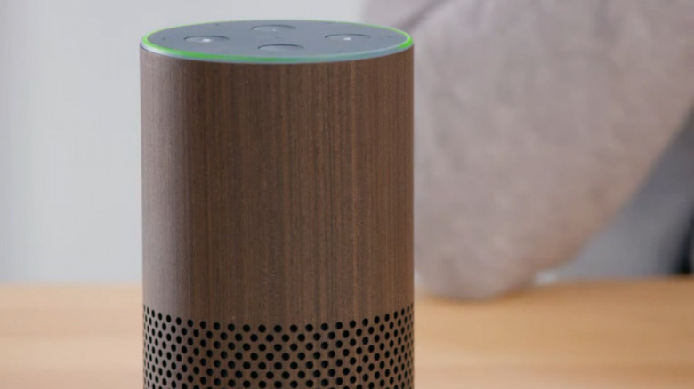 Close up of green light ring around top of echo speaker