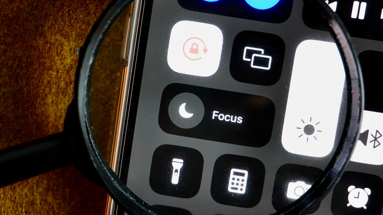 The Focus mode shortcut in the iPhone's Control Center shows a crescent-moon icon.
