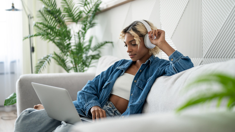 person listening to Apple Music on laptop