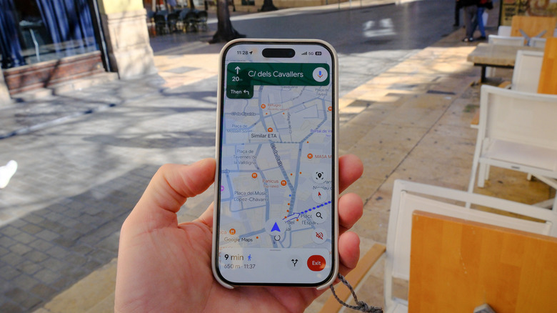 A person holding a phone displaying Google Maps