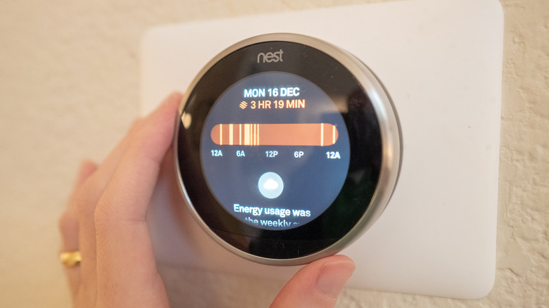 A homeowner adjusts their Nest Thermostat temperature schedule.