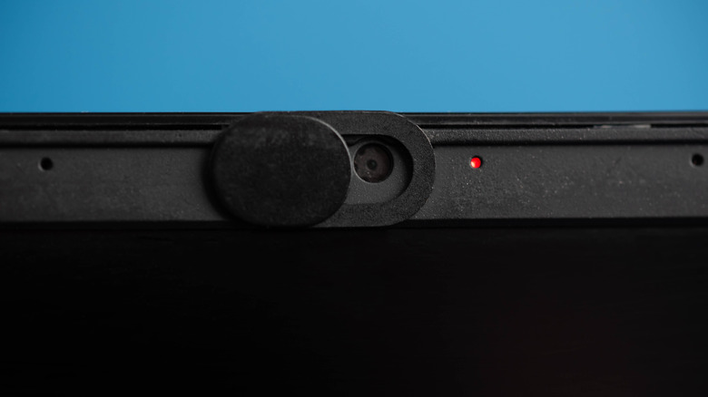 laptop webcam with a privacy shutter and a red dot near it