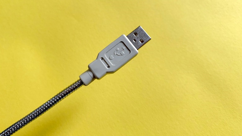Close up of USB trident symbol for High-Speed USB on yellow background.