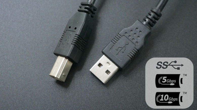 Standard USB 2.0 High-Speed cable in black on background with additional symbols.