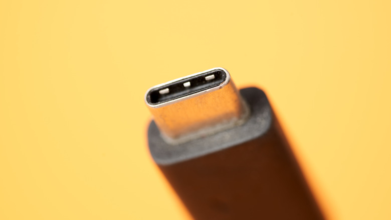 close up of USB-C port on a yellow background