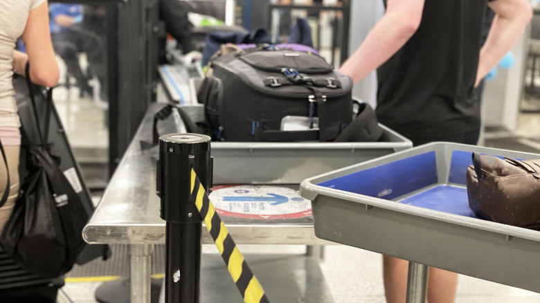 Luggage and bags going through TSA security scans.