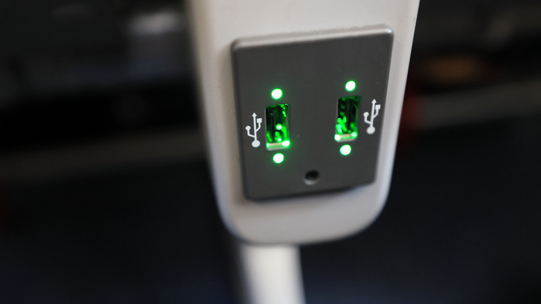 Green USB Port in airplane cabin