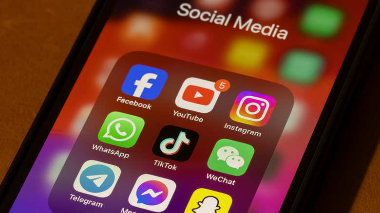 A smartphone with several apps sorted in a Social Media folder.