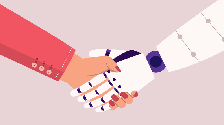 Human hand shaking a robot hand both coming from off screen.