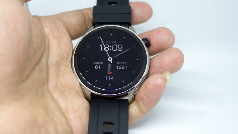 A hand holding the Amazfit GTR 4 smartwatch.